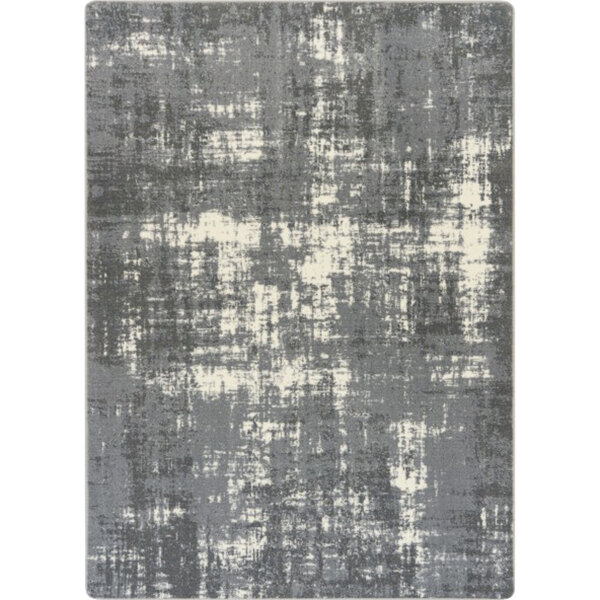 A close-up of a grey and white Joy Carpets Westmarch rectangular area rug with a distressed pattern.