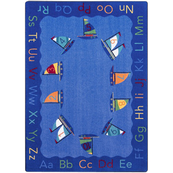 A multicolored rectangular area rug with blue, green, and white colors featuring sailboats and letters.
