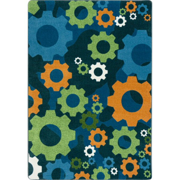 A Joy Carpets rectangular area rug with a colorful pattern of gears in blue and orange.