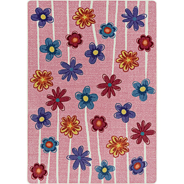 A pink Joy Carpets area rug with colorful flowers on it.