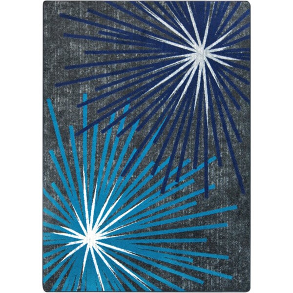 A Joy Carpets rectangular area rug with a blue and white sunburst design.