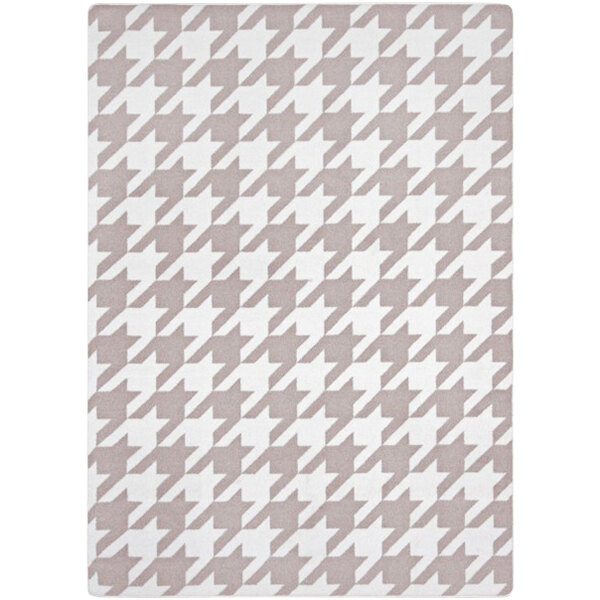 A taupe houndstooth rug with a pattern.