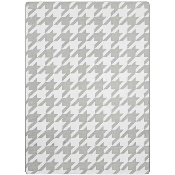 A close-up of a Joy Carpets Morning Fog grey and white houndstooth rug.