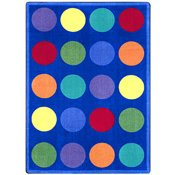 A multi-colored rectangle area rug with colorful circles on a blue background.