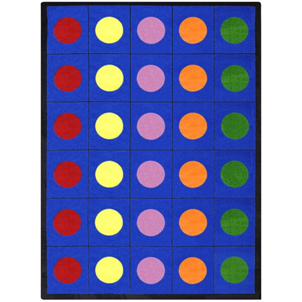 A blue rectangular area rug with multicolored circles in many colors.