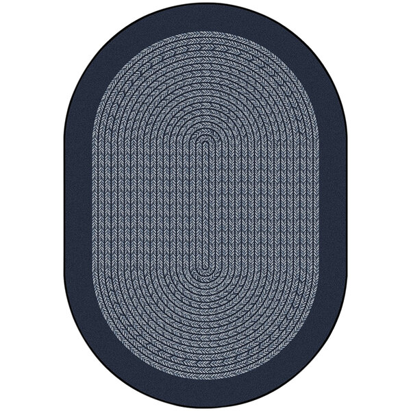 A close up of a navy oval rug with a braided border.