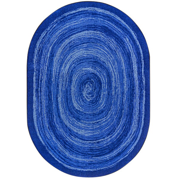 A blue oval rug with white swirls.