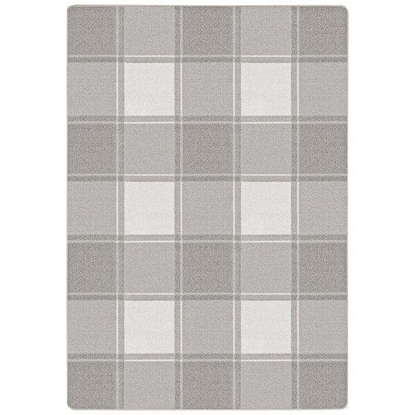 A grey and white plaid Joy Carpets area rug with a white border.