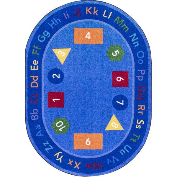 A blue oval area rug with letters and numbers.