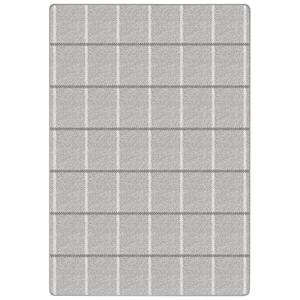 A close-up of a grey plaid rug with white lines.