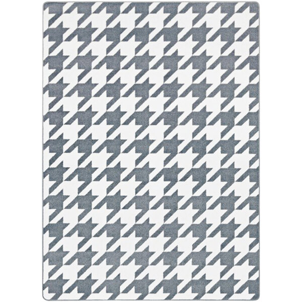 A close-up of a grey and white houndstooth Joy Carpets area rug.