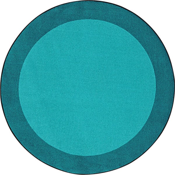 A teal round area rug with a blue circle and black border.