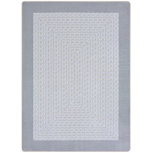 A silver rectangular area rug with a gray geometric pattern.