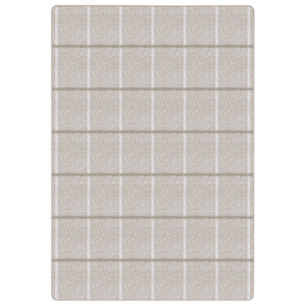 A beige rectangular area rug with squares on it.
