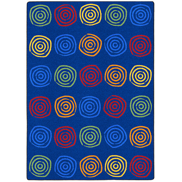 A blue rectangular area rug with colorful circles.