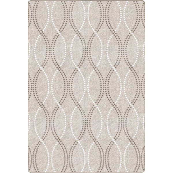 A beige rectangular area rug with a pattern of circles.