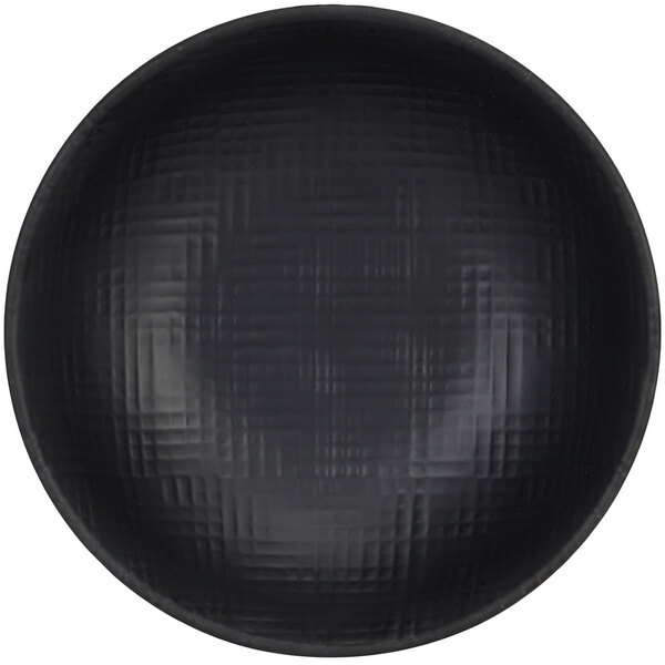 A close-up of a black bowl with a textured surface.