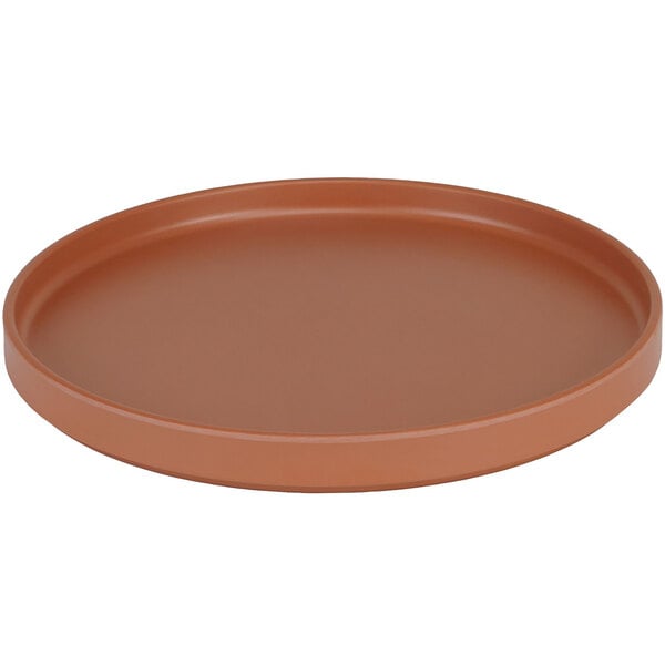 A round brown Cal-Mil Hudson Terra Cotta melamine plate with a low rim.