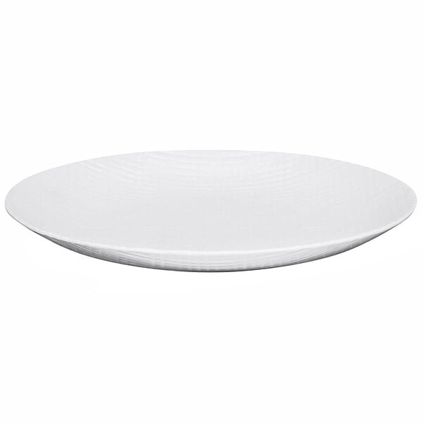 A Cal-Mil Sedona white melamine plate with a textured surface and a wavy edge.
