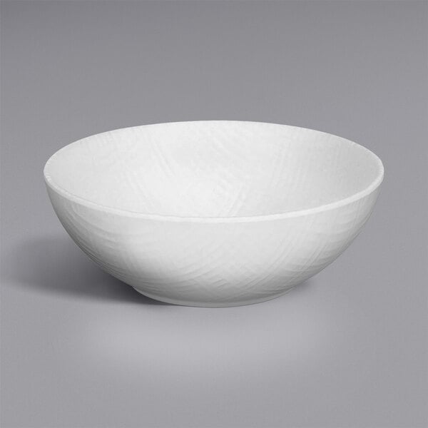 A white Cal-Mil melamine bowl with a curved design.