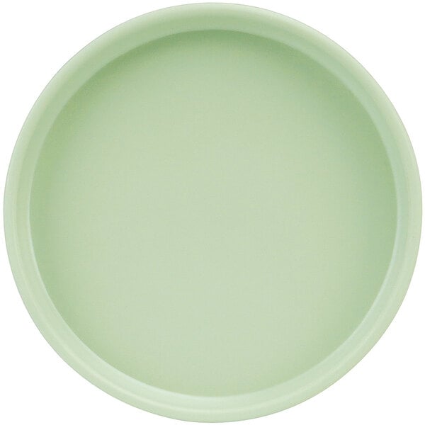 A close-up of a green Cal-Mil 6" Melamine plate with a low rim.