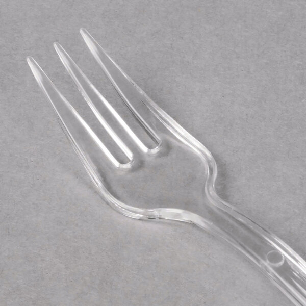 A WNA Comet clear plastic tasting fork.