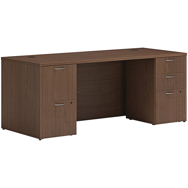A Hon sepia walnut laminate desk with storage pedestals.