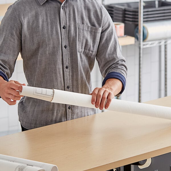 A man holding a white Lavex mailing tube.