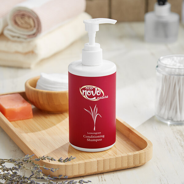 A close up of a white Noble Eco Novo Natura conditioning shampoo bottle with a black top on a tray.