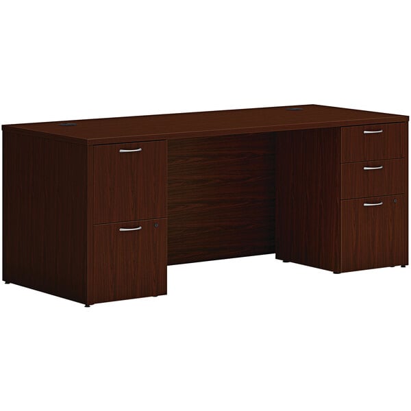 A traditional mahogany Hon desk with 2 storage pedestals.