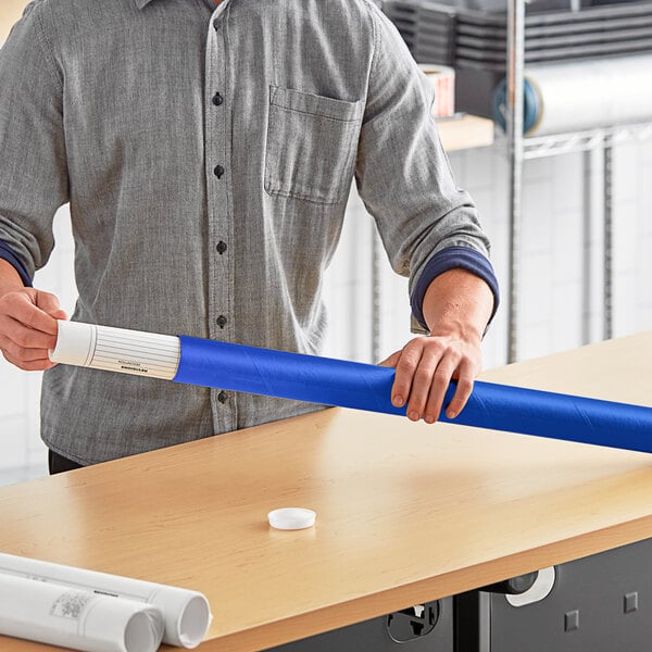 A man holding a blue Lavex mailing tube.