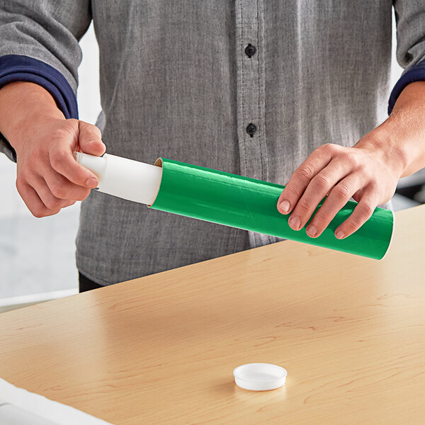 A man holding a green Lavex mailing tube.