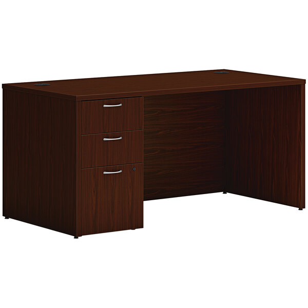 A traditional mahogany Hon laminate desk with storage pedestal.