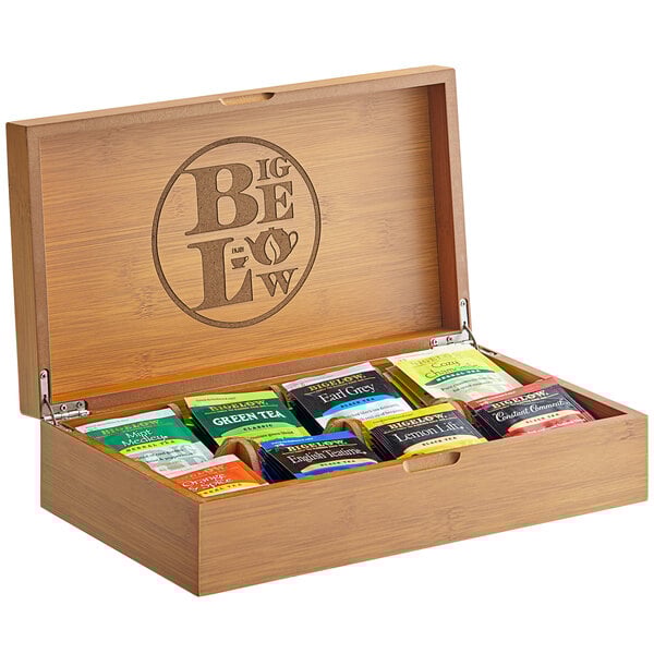 A Bigelow Tea wooden box with 8 compartments filled with assorted tea bags.