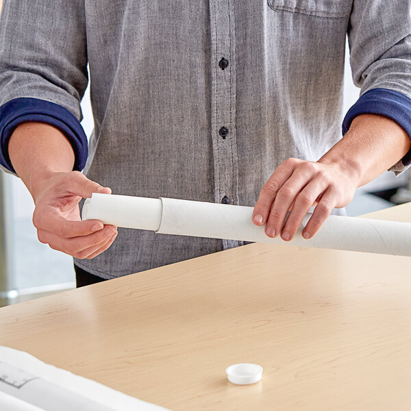 A man holding a white Lavex mailing tube.