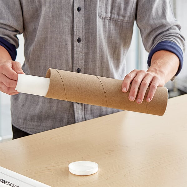 A man holding a Lavex Kraft mailing tube.