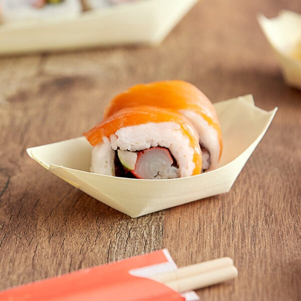 A sushi roll in an EcoChoice wooden paper boat.