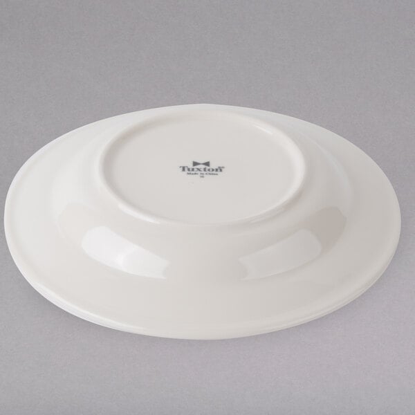 A white Tuxton pasta bowl with a wide rim and a rolled edge.