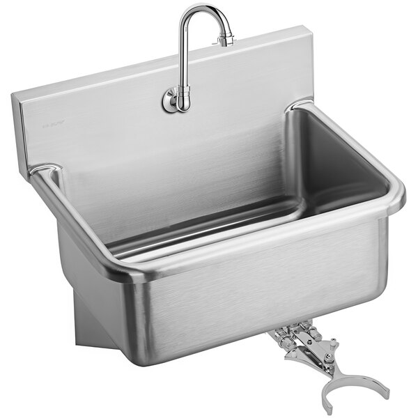 A Zurn stainless steel wall mounted utility sink with a knee-operated faucet.