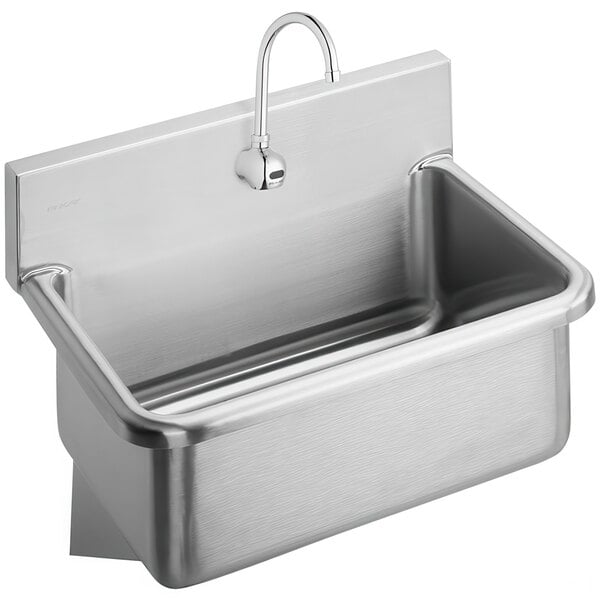 A Zurn stainless steel wall mounted hands-free sink with a gooseneck sensor faucet.