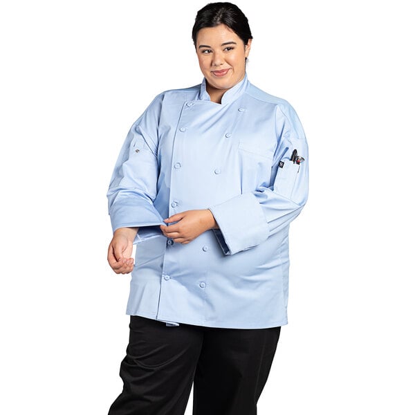 A woman wearing a sky blue Uncommon Chef long sleeve chef coat with mesh back.