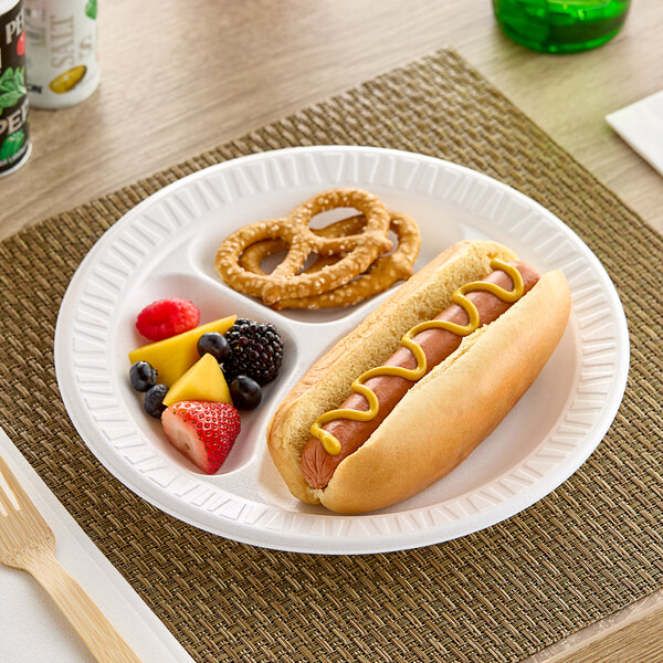 A white Dart Concorde foam plate with a hot dog and other food on it.