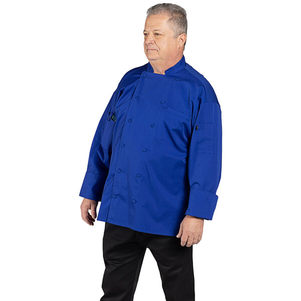 A man wearing a deep royal blue Uncommon Chef Vigor Pro Vent long sleeve chef coat.