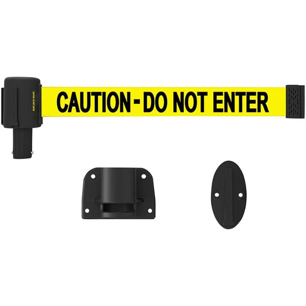 A yellow Banner Stakes retractable belt with black text reading "Caution-Do Not Enter" on a black oval wall mount with two holes.