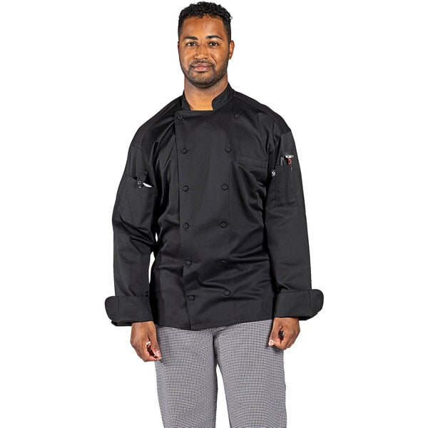 A man wearing an Uncommon Chef black long sleeve chef coat with a mesh back.