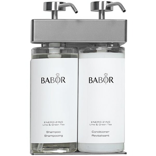 A white Dispenser Amenities wall mounted shower dispenser with oval Babor bottles and black text.