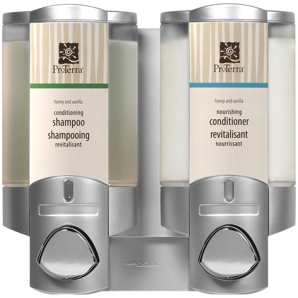 A silver Dispenser Amenities Aviva wall-mounted shower dispenser with two translucent bottles.