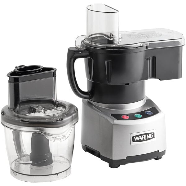 A Waring commercial food processor with a clear container next to it.