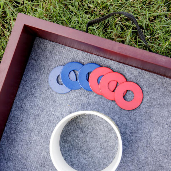 A red and blue circular objects on a grey surface.