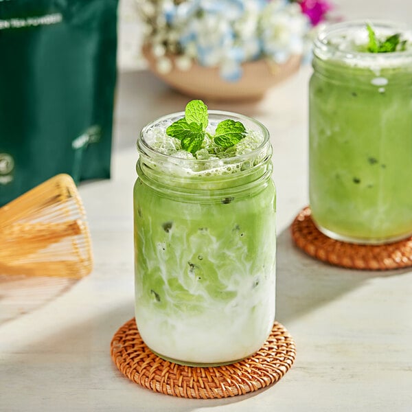 A glass jar of Tenzo matcha green tea with mint leaves.